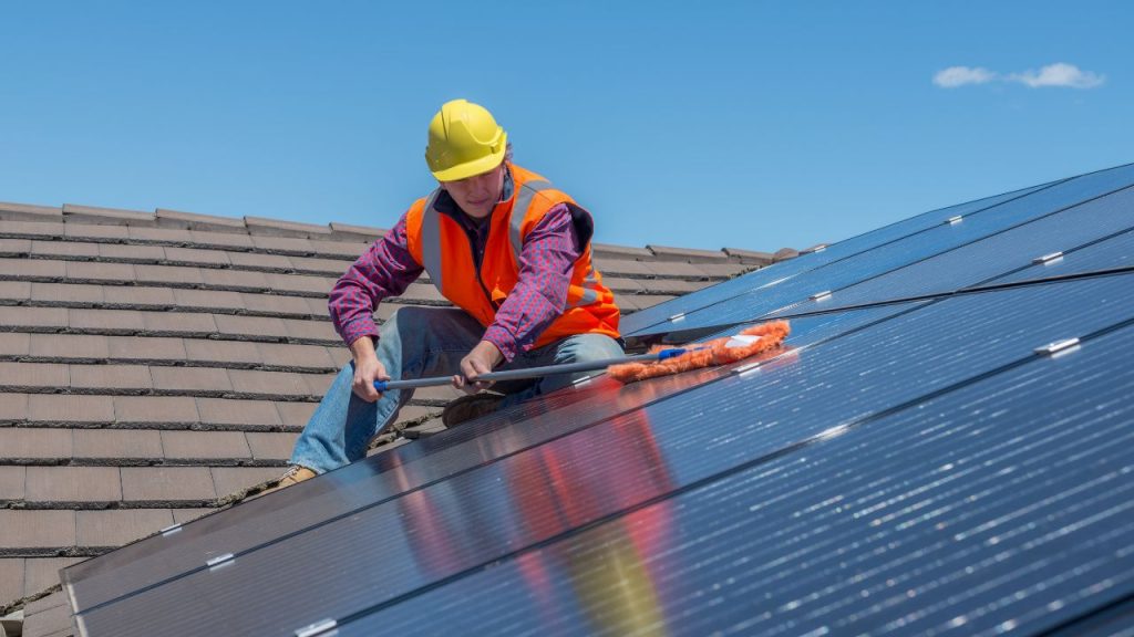 technician performing a solar panel cleaning - Clay Solar Installation Partners